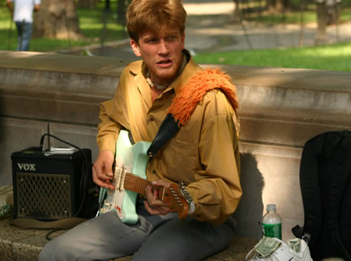 Under a new “clarification” of city parks regulations, musicians who want to collect donations in city parks must confine themselves to certain areas. Above, a guitarist called Gypsy Joe Hocking performs in Central Park. 