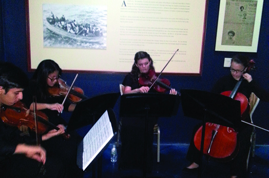 Musicians perform "Nearer, My God, to Thee," a hymn played by the Titanic band members before they went down with the ship. The performance was part of an unveiling ceremony at the "Titanic: The Experience" exhibition in Orlando to show off the newly-discovered plaque honoring the Titanic musicians.