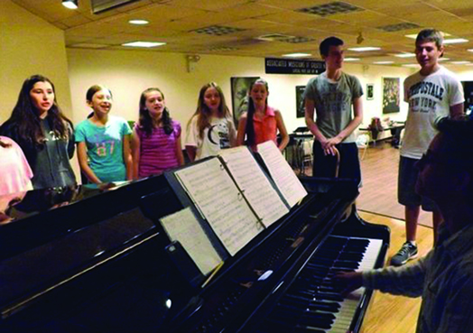 Students at Summer Stock Jr. practice their musical instruments under the capable rehearsal direction of Local 802 member BJ Gandalfo. The program is in its fourth year.