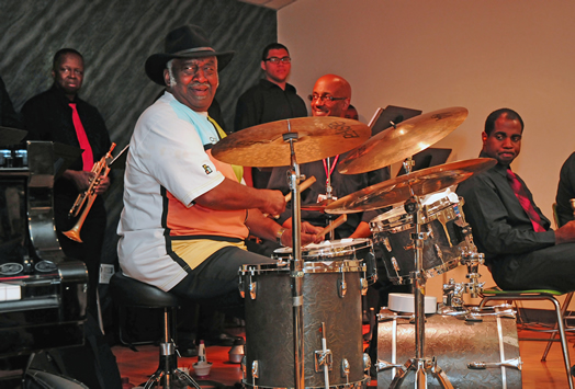 Bernard "Pretty" Purdie (left) and Rob Paprozzi (middle) raise the heart at a recent workshop at Local 802, featuring students from the York College Big Band under the direction of Tom Zlabinger.