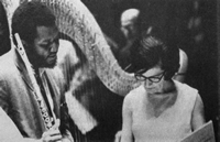 The late harpist Gloria Agostini consults with flutist Harold Jones during a rehearsal.