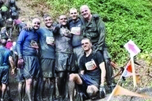 Daniel McCaughan (far right) with his sons, participating in Tough Mudder, a fundraiser for the Wounded Warrior Project held in the shadow of Mount Rainier
