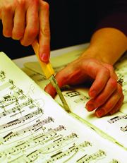 Melissa Robason repairs a page of Strauss' "Arabella."