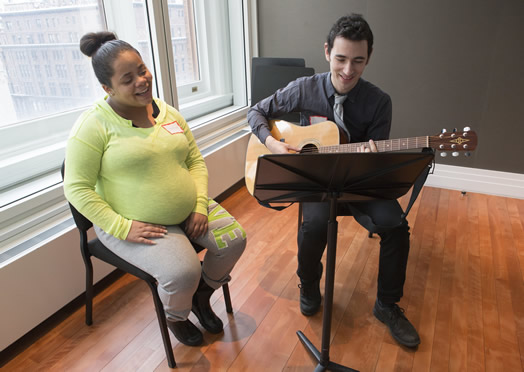 Local 802 member Daniel Linden works with an expectant mother to write a lullaby, through a program called - what else? - the Lullaby Project. Photo: Jennifer Taylor