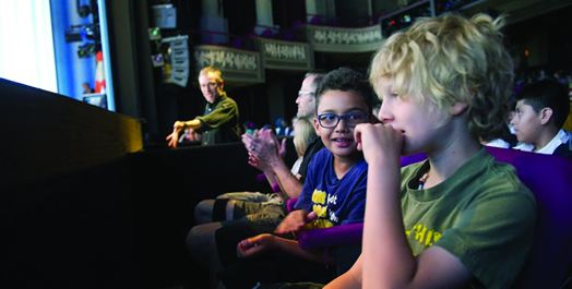 THE POWER OF LIVE MUSIC: NYC schoolchildren enjoy excerpts of Broadway shows at this year's Creating the Magic programs sponsored by Inside Broadway. In the background, Local 802 member Rob Preuss conducts.