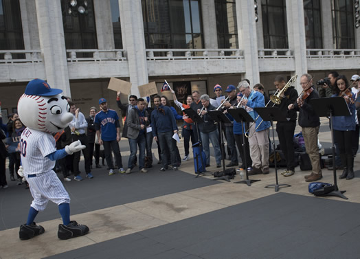 MR. MET MEETS THE MET ORCHESTRA: On the morning of game #1 of the World Series, Mr. Met came to the steps of Lincoln Center to rally with the Met Orchestra, which performed "Meet the Mets," in an arrangement by Met trumpeter Peter Bond that was conducted by Mr. Met himself. The event was organized by Susan Spector, second oboist of the Met Orchestra since 1992 and a die-hard Mets fan, and Lincoln Center security guard Avo Asencio, who has a cousin who works in the Mets' marketing department.