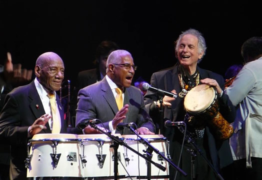 David Amram, as a featured guest with Bobby Sanabria’s orchestra, playing with Candido (left) and Felipe Luciano at the Apollo Theater in 2011 for a tribute to the legacy of Mario Bauza, the master of Afro-Cuban jazz.