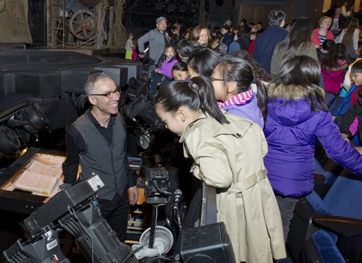 Ric Molina shows visiting NYC public school children the mysteries of the orchestra pit at "Wicked." Photo: Elena Olivo