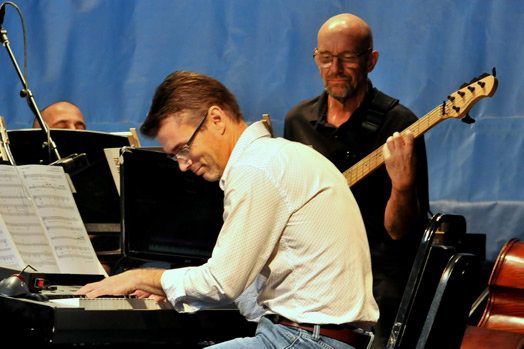Jason Howland at the keyboard; Randy Landau standing behind