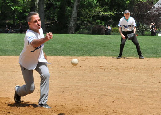 Tony Danza pitches a fastball, while Pat Milando watches in amazement.