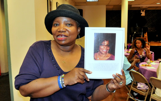 Pamela Wilkins holding up a picture of her sister Leslie.