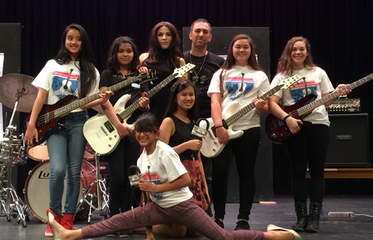 SHARING THE JOY OF MUSIC: Local 802 member Damon Marks (center) formed a foundation to donate musical instruments to schools.