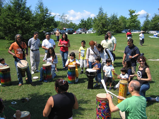 Local 802 members Bashiri Johnson (with mallets at far left) and Valerie Ghent (far right) at a Feel the Music drumming workshop.